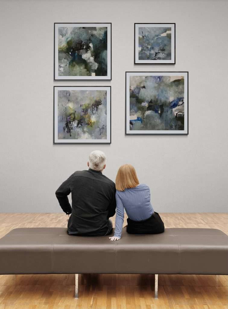 Visitors seated in gallery space viewing abstract paintings by Rita Thorp